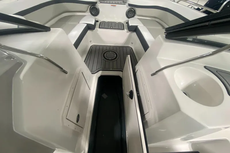 Slide: The Image of 2026 Starcraft SVX 210 boat interior with storage compartments and seating. - 27
