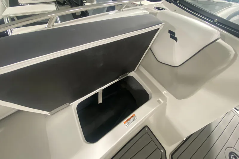 Slide: The Image of 2026 Starcraft SVX 210 boat storage compartment with open lid, showcasing interior space. - 30