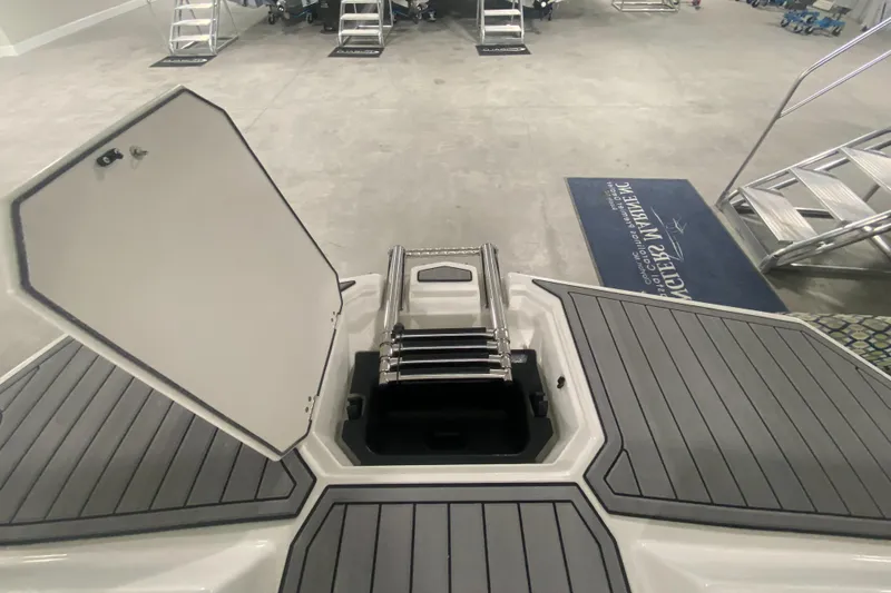 Slide: The Image of 2026 Starcraft SVX 210 boat with open hatch and ladder in showroom. - 33
