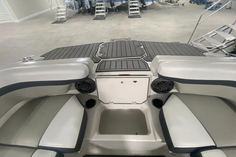 Slide: The Image of 2026 Starcraft SVX 210 boat interior with seating, speakers, and storage compartment. - 34