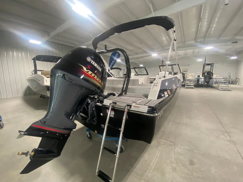 Slide: The Image of 2026 Starcraft SVX 210 boat with Yamaha outboard motor in a showroom. - 4
