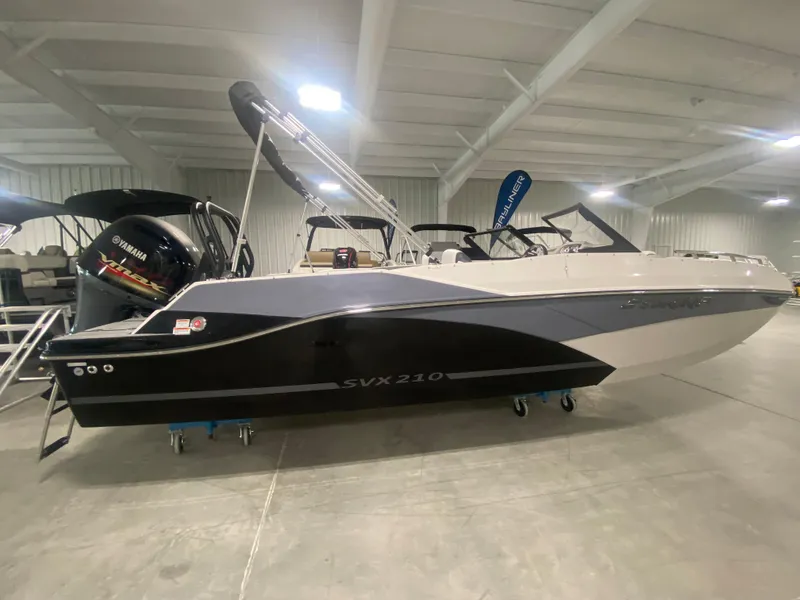 The Image of 2026 Starcraft SVX 210 boat displayed indoors, featuring sleek design and modern features. - 1