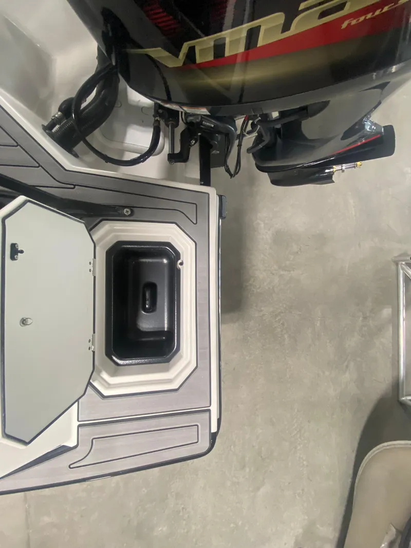 Slide: The Image of 2026 Starcraft SVX 210 boat engine and storage compartment, top view. - 16