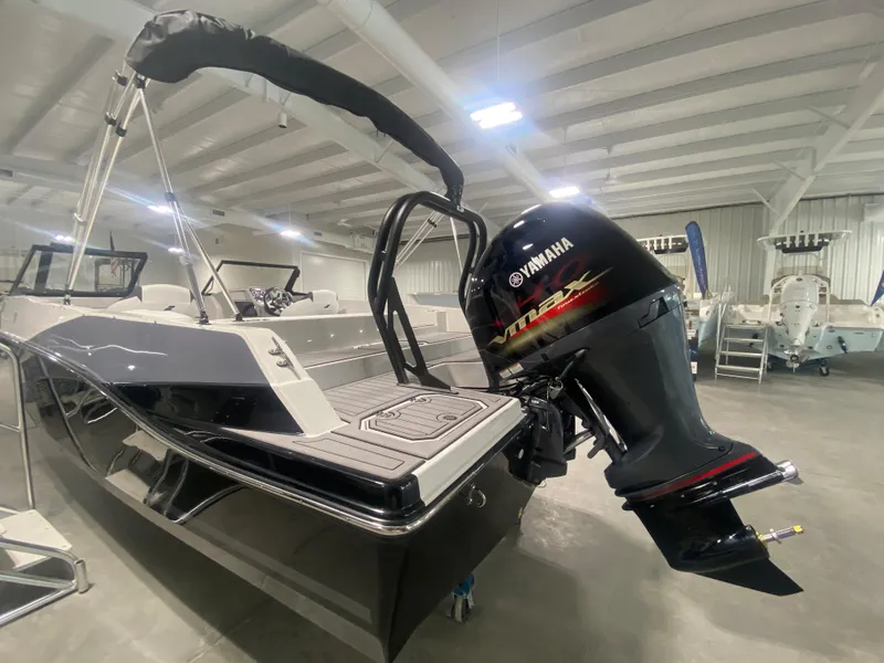 Slide: The Image of 2026 Starcraft SVX 210 boat with Yamaha outboard motor in showroom. - 17