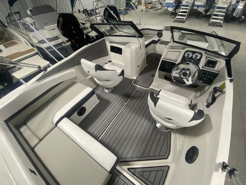 Slide: The Image of 2026 Starcraft SVX 210 boat interior with modern seating and dashboard design. - 18