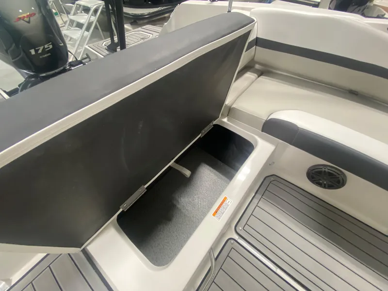 Slide: The Image of 2026 Starcraft SVX 210 boat interior with open storage compartment and seating. - 20
