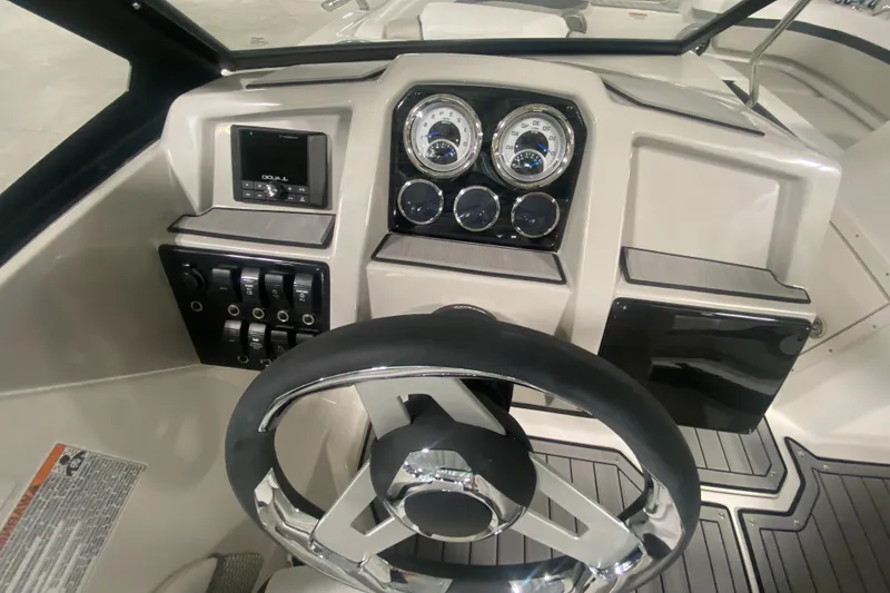 Slide: The Image of 2026 Starcraft SVX 210 boat dashboard with steering wheel and control panel. - 22