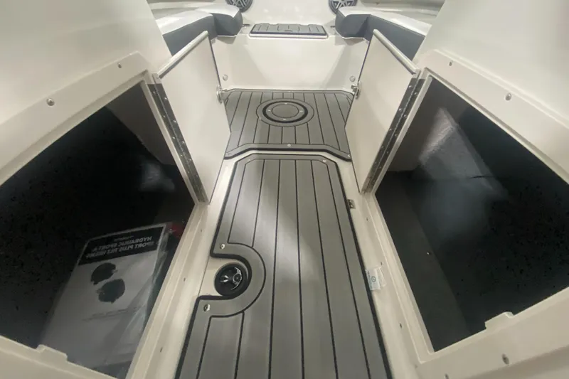 Slide: The Image of 2026 Starcraft SVX 210 boat interior with storage compartments and sleek flooring. - 28