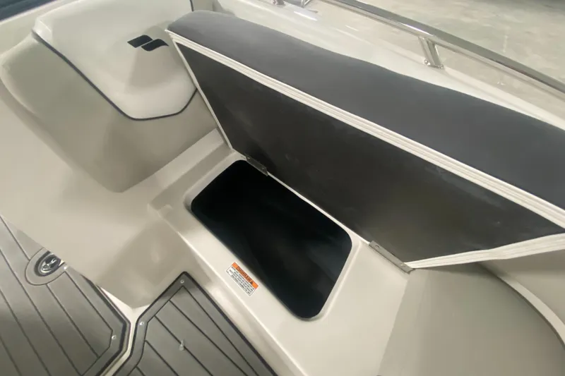 Slide: The Image of 2026 Starcraft SVX 210 boat storage compartment with open lid, showcasing interior space. - 32