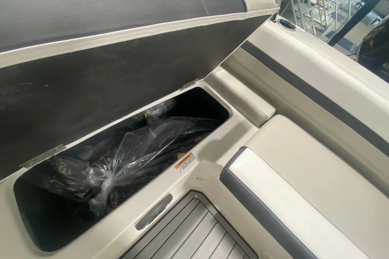 Slide: The Image of 2026 Starcraft SVX 210 boat storage compartment with open lid, showcasing spacious interior. - 36