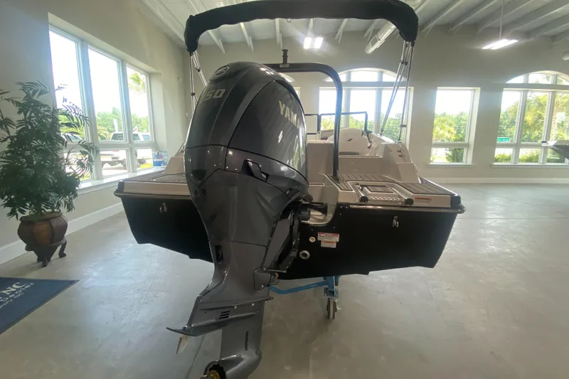 Slide: The Image of 2026 Starcraft SVX 190 boat with Yamaha outboard motor in showroom. - 3