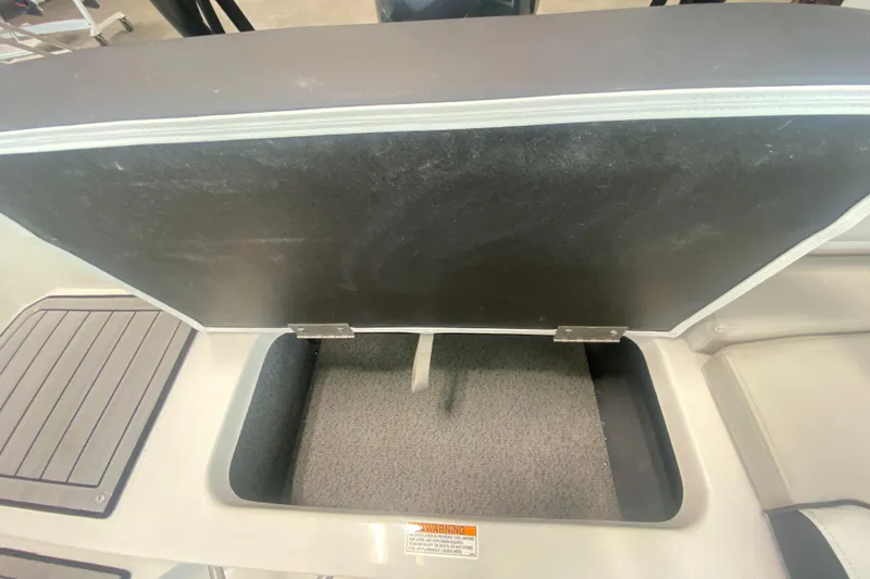 Slide: The Image of Open storage compartment on 2026 Starcraft SVX 190 boat, featuring carpeted interior. - 8
