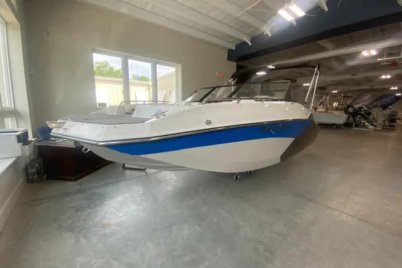 Slide: The Image of 2024 Starcraft SVX 190 boat displayed in a showroom. - 1
