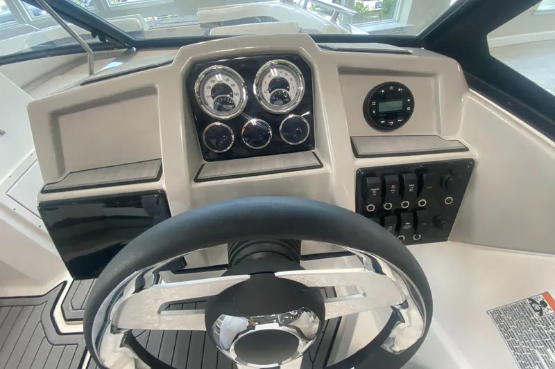 Slide: The Image of 2024 Starcraft SVX 190 boat dashboard with steering wheel and control panel. - 12