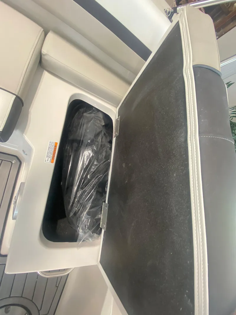 Slide: The Image of 2024 Starcraft SVX 190 boat storage compartment with open lid. - 7
