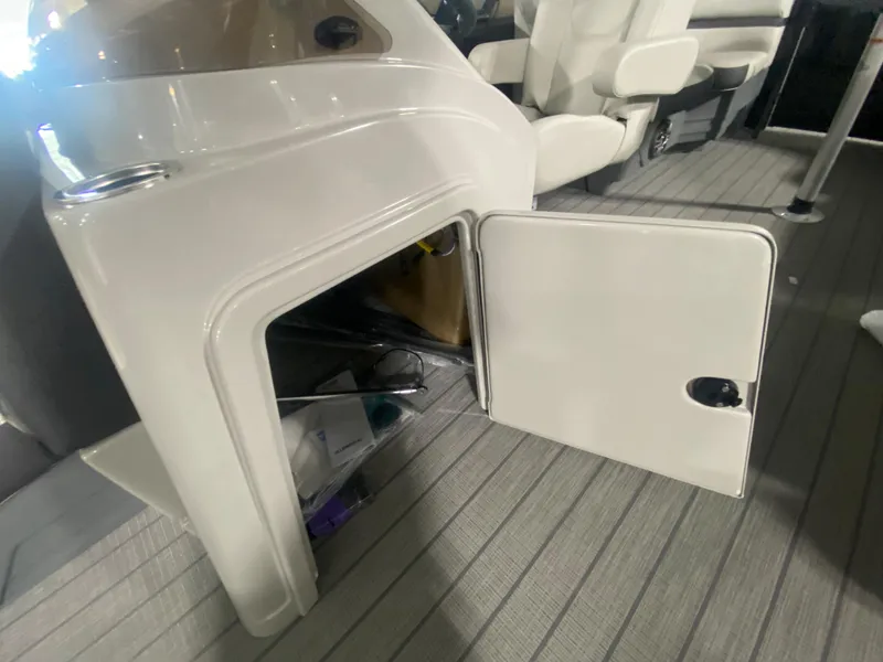Slide: The Image of 2024 Starcraft EXS 1 boat interior storage compartment with open door. - 12