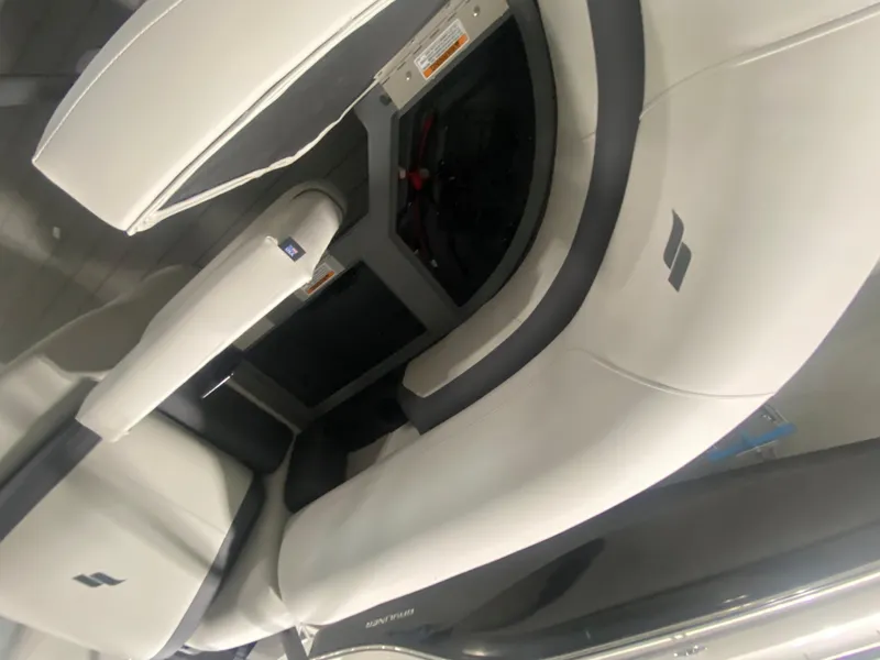 Slide: The Image of 2024 Starcraft EXS 1 boat interior seating with white and gray upholstery. - 13