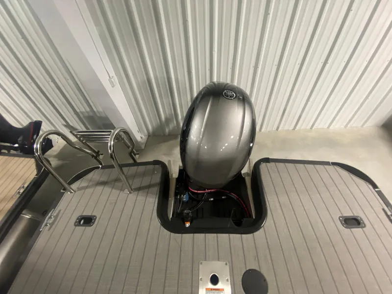 Slide: The Image of 2024 Starcraft EXS 1 boat with outboard motor and swim ladder. - 14