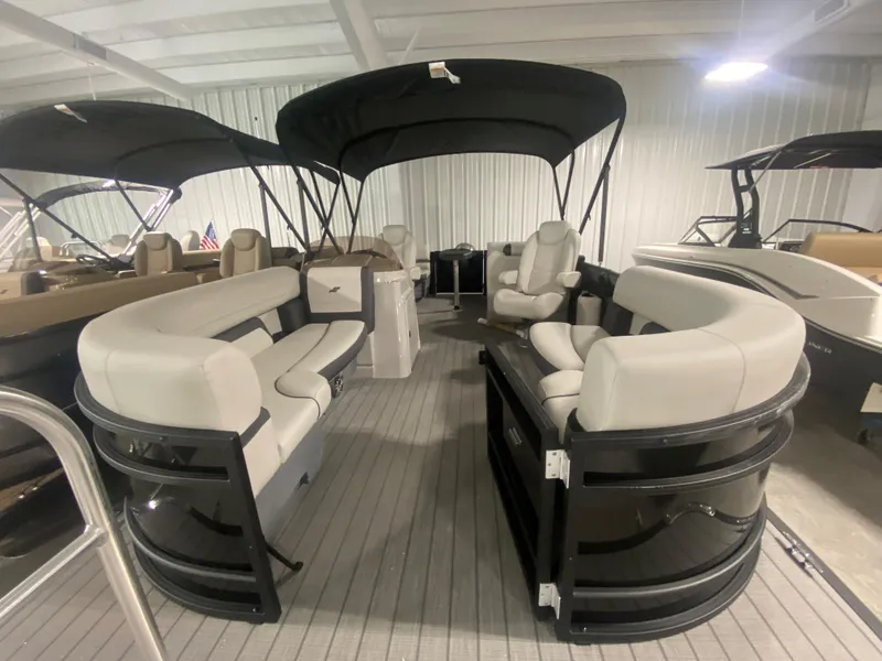 Slide: The Image of 2024 Starcraft EXS 1 pontoon boat with spacious seating and black canopy. - 18