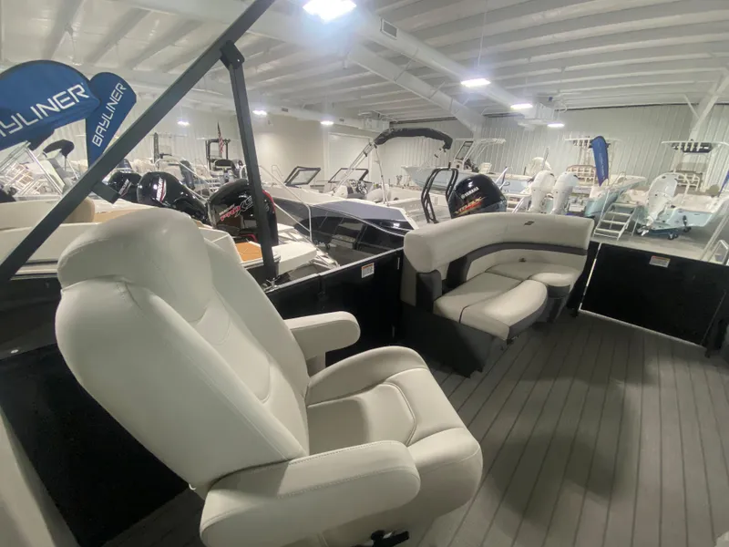 Slide: The Image of 2024 Starcraft EXS 1 boat interior with white seating in a showroom. - 8