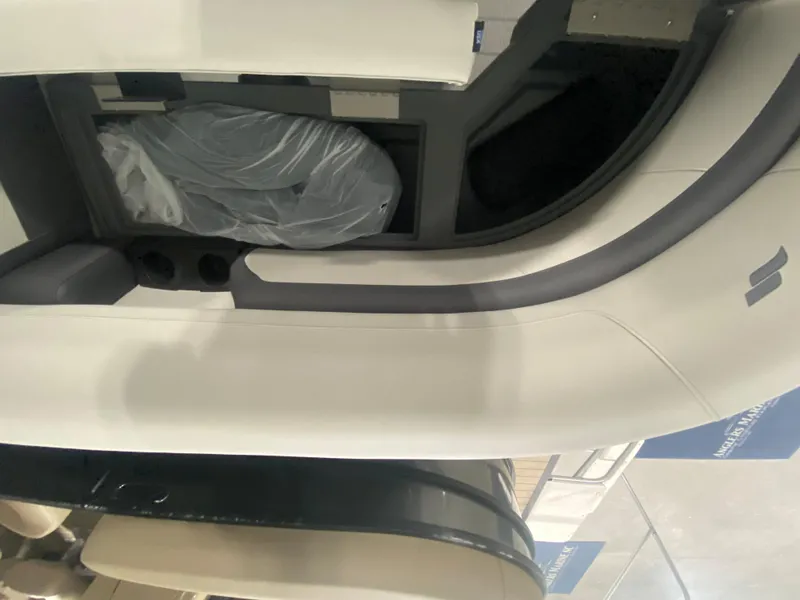 Slide: The Image of 2024 Starcraft EXS 1 boat interior seating with storage compartment. - 11