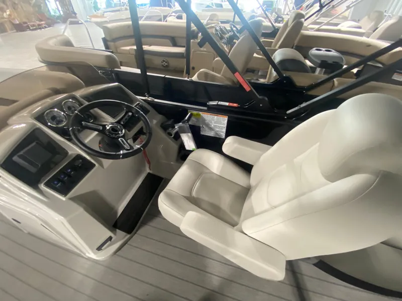 Slide: The Image of 2024 Starcraft EXS 1 boat interior with steering wheel and captain's chair. - 15