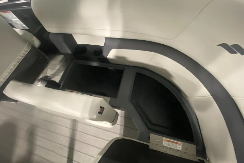 Slide: The Image of 2024 Starcraft EXS 1 boat interior seating and storage compartments. - 20