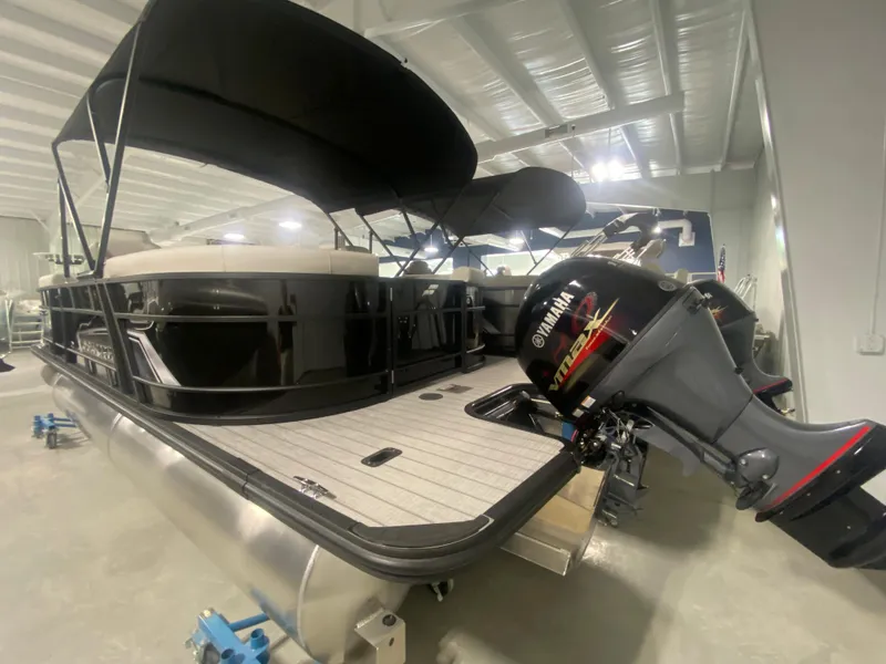 Slide: The Image of 2024 Starcraft EXS 1 pontoon boat with Yamaha outboard motor in showroom. - 3