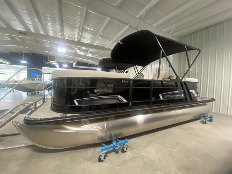 Slide: The Image of 2024 Starcraft EXS 1 pontoon boat in showroom. - 1