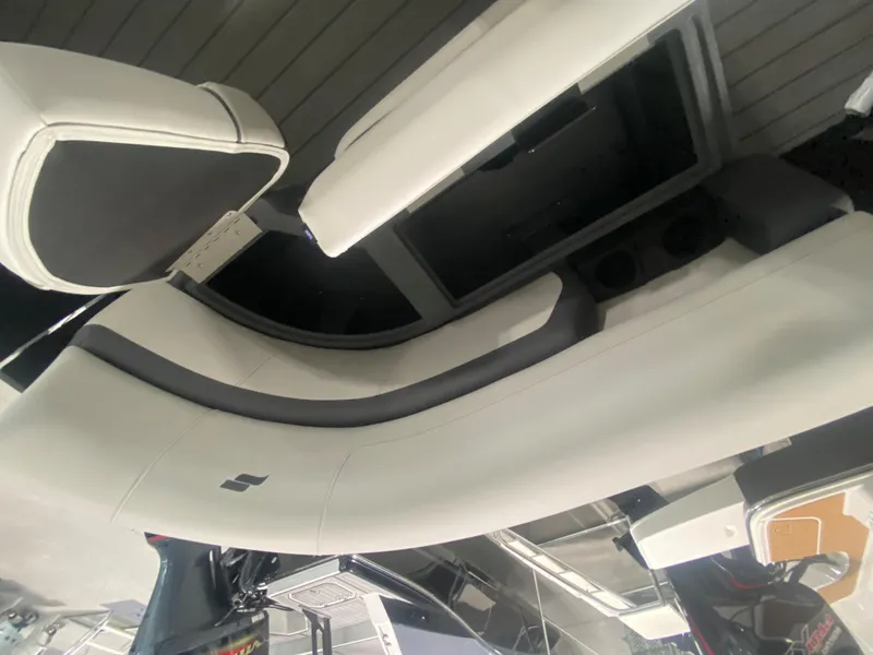 Slide: The Image of 2024 Starcraft EXS 1 boat interior seating with white and black upholstery. - 16