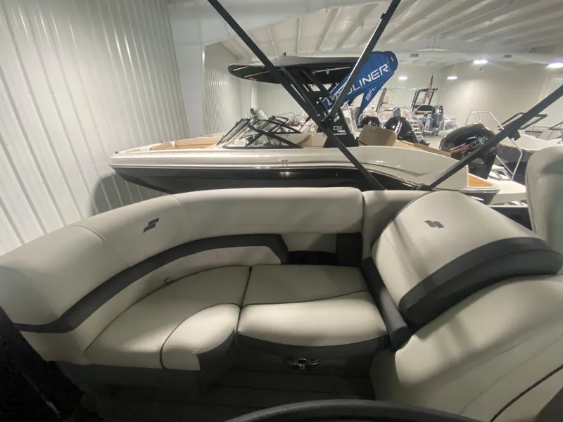 Slide: The Image of 2024 Starcraft EXS 1 boat interior with plush seating in a showroom. - 9