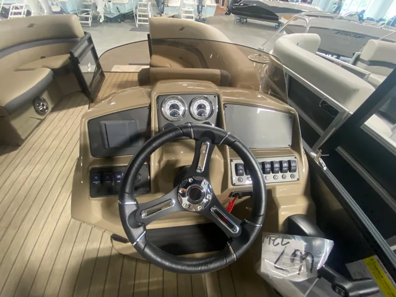 Slide: The Image of 2024 Starcraft EXS 1 boat dashboard with steering wheel and control panels. - 10