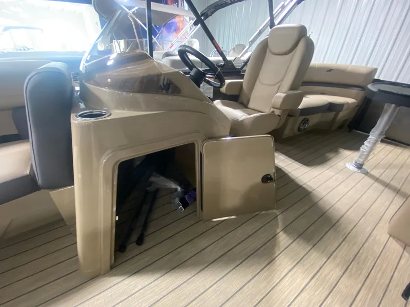 Slide: The Image of 2024 Starcraft EXS 1 boat interior with open storage compartment and captain's chair. - 14