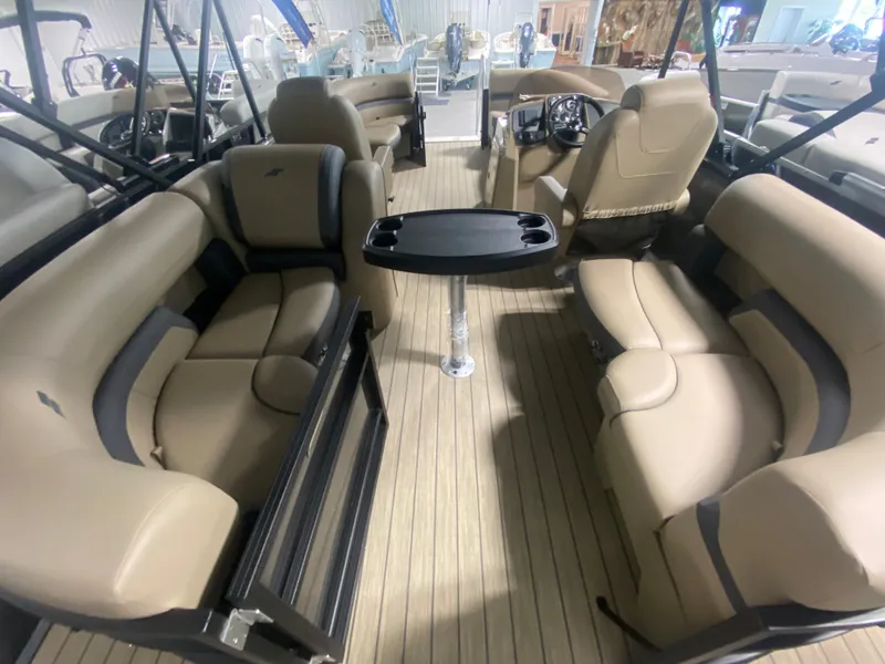 Slide: The Image of 2024 Starcraft EXS 1 boat interior with beige seating and central table. - 5