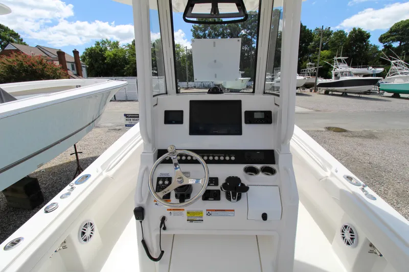 Slide: The Image of 2024 Regulator 23 boat console with steering wheel, controls, and navigation screen. - 10