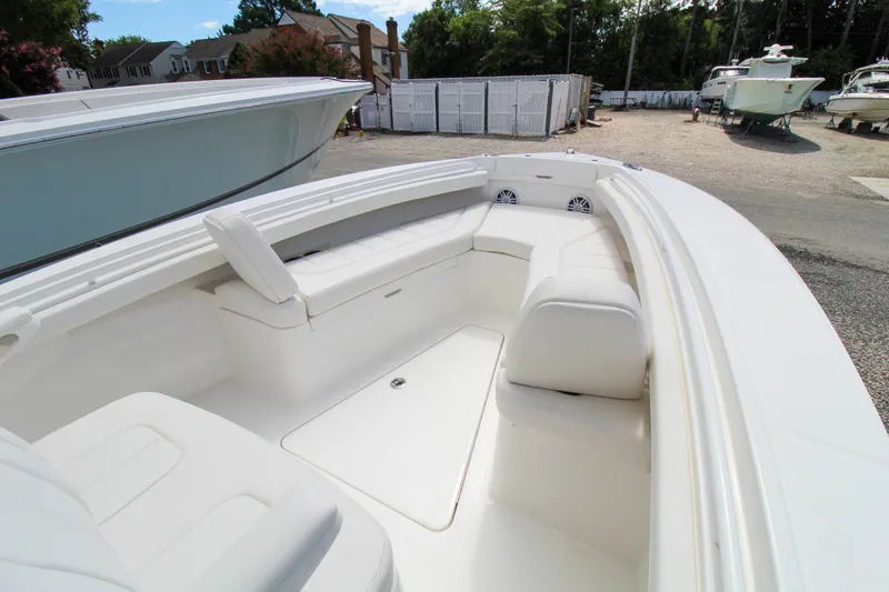 Slide: The Image of 2024 Regulator 23 boat interior with white seating and storage compartments. - 13