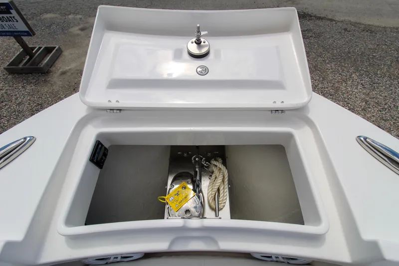 Slide: The Image of 2024 Regulator 23 boat anchor storage compartment with lid open. - 15