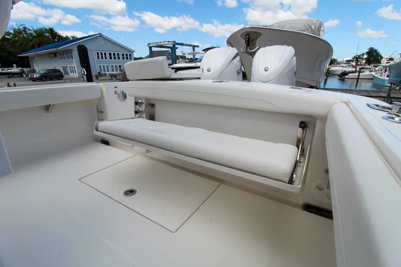 Slide: The Image of 2024 Regulator 23 boat with fold-down seating and twin outboard engines. - 19
