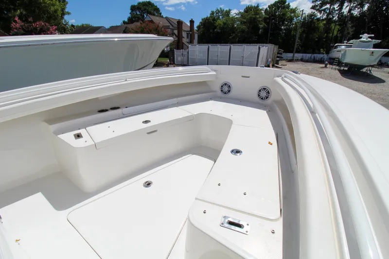 Slide: The Image of 2024 Regulator 23 boat interior with seating and storage compartments. - 23