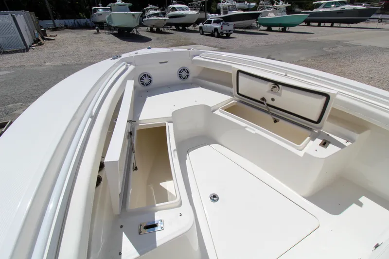 Slide: The Image of 2024 Regulator 23 boat interior with open storage compartments. - 24