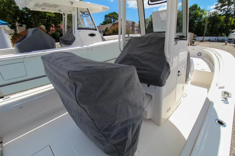 Slide: The Image of 2024 Regulator 23 boat interior with covered seats and center console. - 26