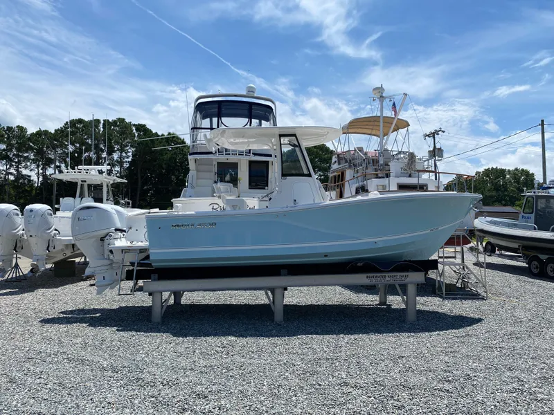 Slide: The Image of 2024 Regulator 23 boat on display at a marina. - 27