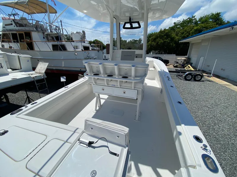 Slide: The Image of 2024 Regulator 23 boat interior with fishing rod holders and Garmin navigation system. - 28