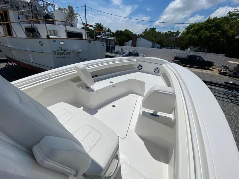 Slide: The Image of 2024 Regulator 23 boat interior with seating and storage compartments. - 30
