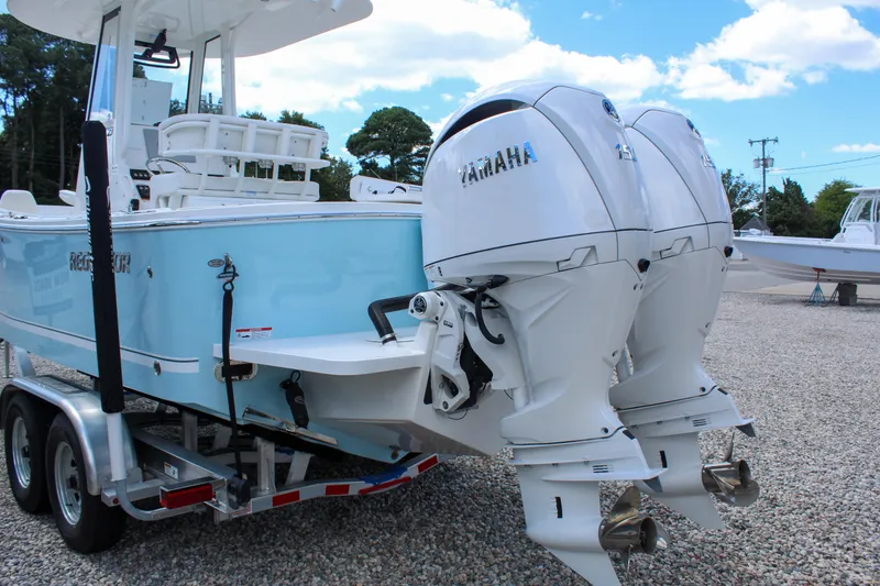Slide: The Image of 2024 Regulator 23 boat with twin Yamaha outboard engines on a trailer. - 4