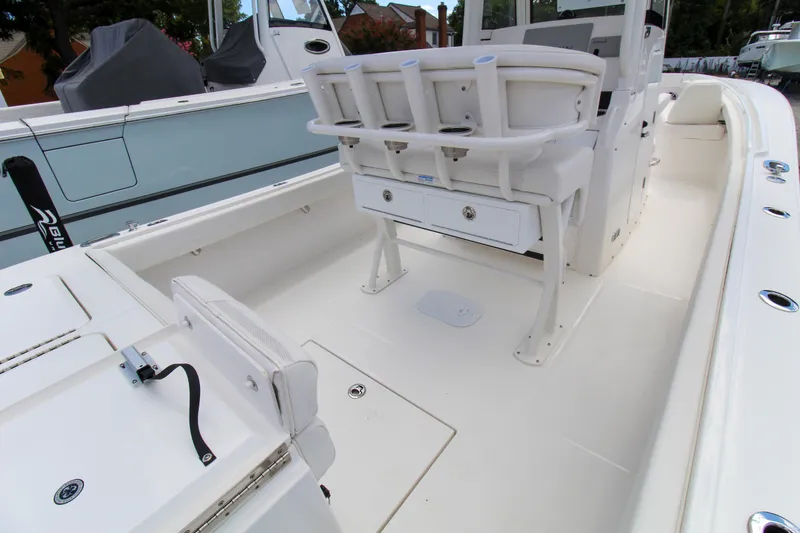 Slide: The Image of 2024 Regulator 23 boat interior with rod holders and storage compartments. - 6