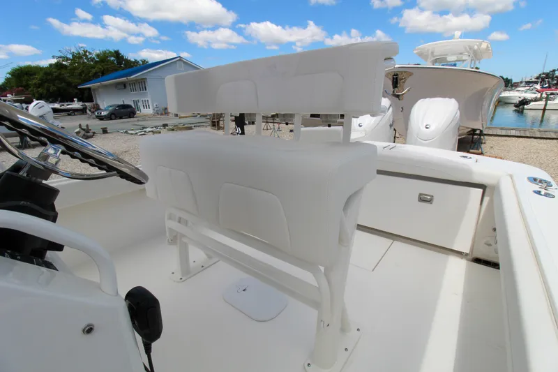 Slide: The Image of 2024 Regulator 23 boat interior with white seating and steering wheel. - 9