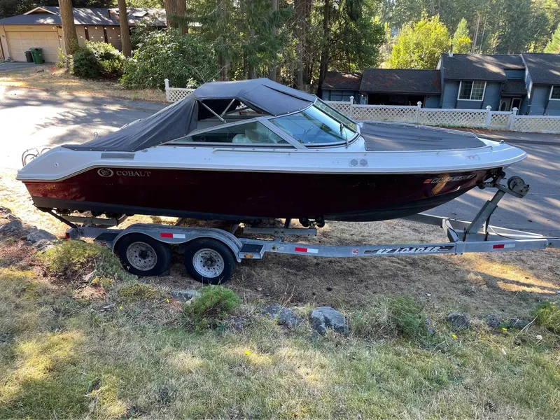 The Image of 1989 Cobalt CONDURRE boat on trailer, parked in a residential area. - 0