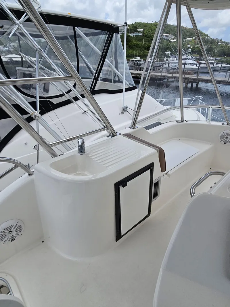 Slide: The Image of Flybridge of 2007 Riviera 42 yacht with marina view in background. - 13