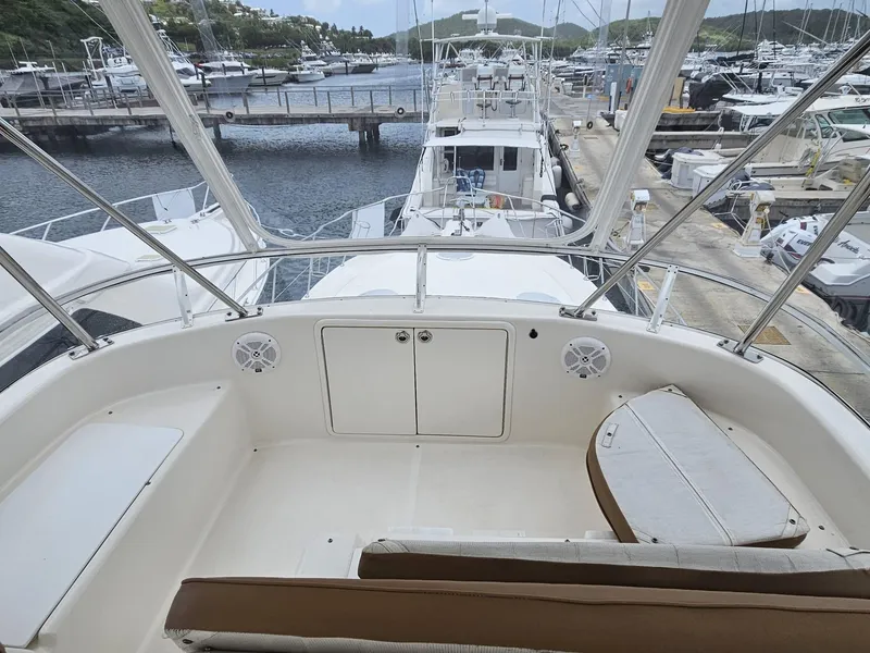 Slide: The Image of Flybridge view of 2007 Riviera 42 yacht docked at marina, showcasing seating and controls. - 14